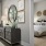 a bed in a bedroom behind attached to a living room with decor